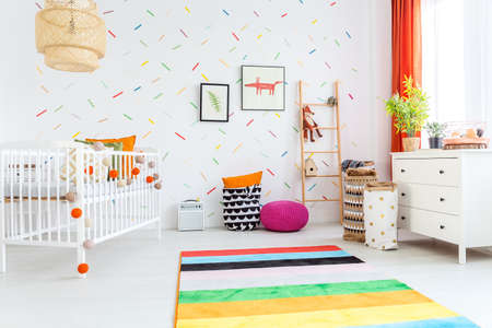 Spacious white room with cradle designed for kidsの写真素材