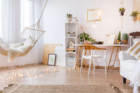Cozy working place in the white room with hammockの写真素材