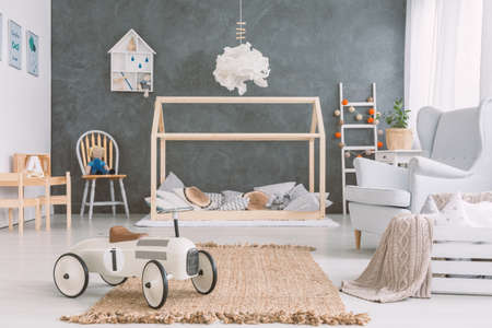 Baby room in scandinavian style with armchair and wood bedの写真素材