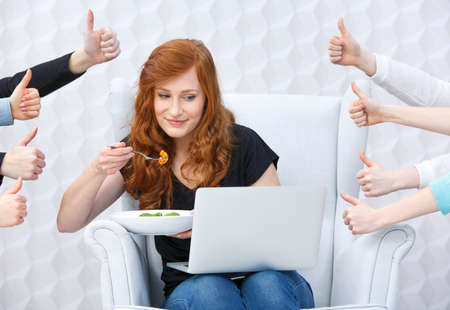 Food blogger with laptop, around hands holding thumbs upの写真素材