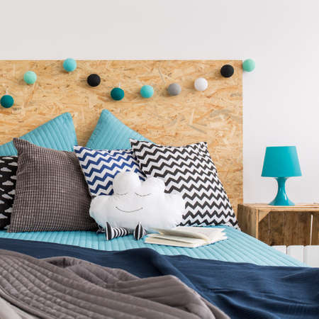 Large bed with decorative pillowsの写真素材