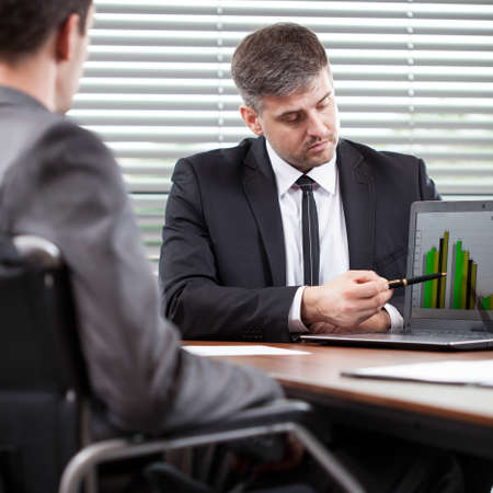 Disabled man working with his colleagues at the office