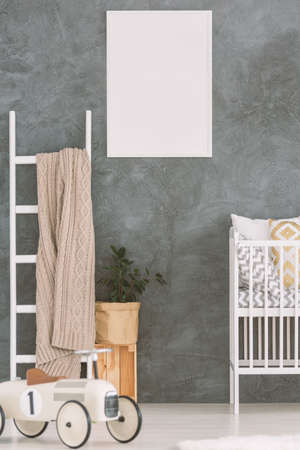 Child bedroom in scandi style with cot and wood ladderの写真素材