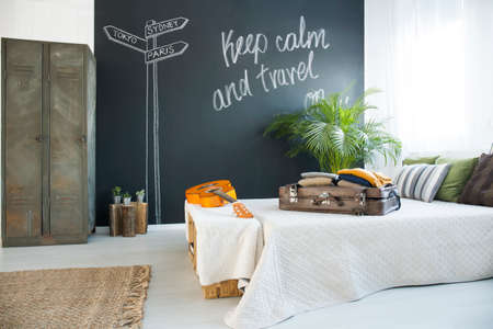 King-size bed in cozy bedroom with chalkboard wall
