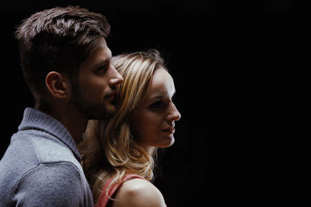 Young beautiful couple looking ahead and smilingの写真素材