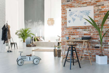 Cozy spacious studio apartment with brick wallの写真素材