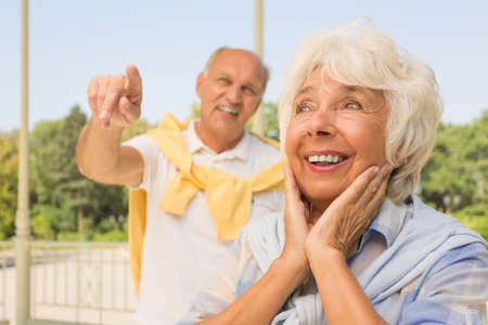Happy old couple enjoying summer day in the parkの写真素材