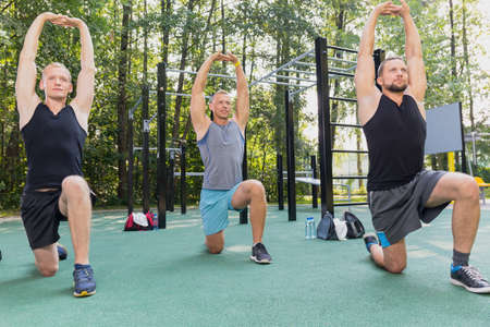Handsome atheltic men having calisthenics workout in parkの写真素材