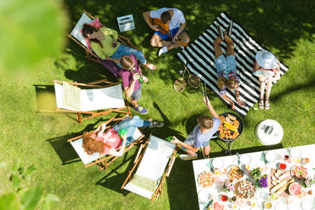 Top view of friends having grill in gardenの写真素材