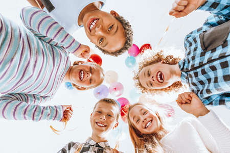 Group of happy children holding balloons and having funの写真素材