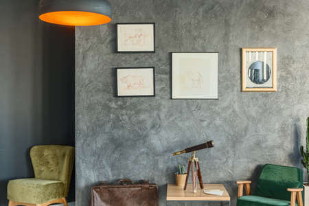Traveller's living room design decorated with drawings and green chairsの写真素材