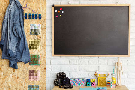 Creative room design with blackboard and desk with accessoriesの写真素材