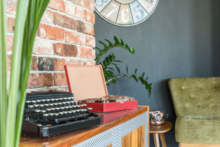 Black typewriter on a cabinet in old-school living roomの写真素材