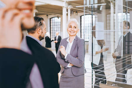 Content woman boss talking with client in modern officeの写真素材