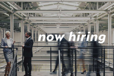 Business couple talking about contract, standing in modern office buildingの写真素材