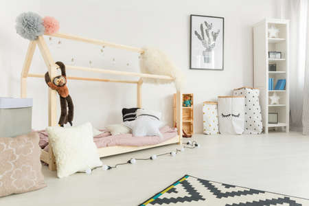 White, scandi style child bedroom with bed and bookcaseの写真素材