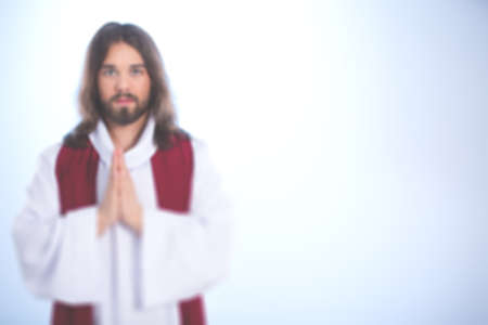 Illuminated Jesus Christ holding hands in amen gestureの写真素材