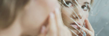 Reflection of depressed girl with dual personality