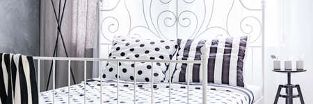 Black and white bed in stylish woman's bedroomの写真素材