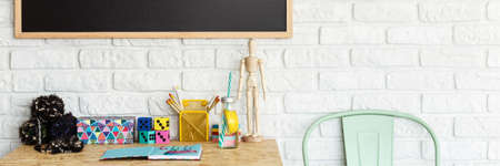 Intertior with brick wall, blackboard and creative, multifunctional desk, panoramaの写真素材