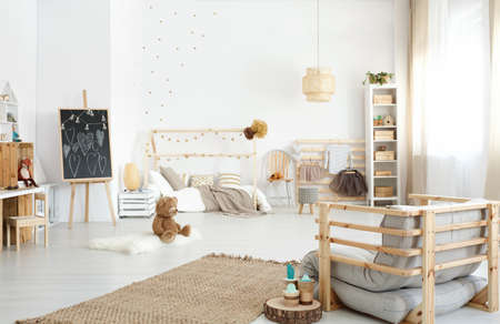 Spacious modern kid's bedroom with armchair, toys and diy accessoriesの写真素材