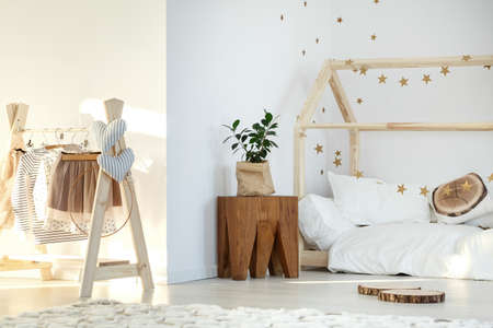 Stylish girl's room with bed and wooden accessoriesの写真素材