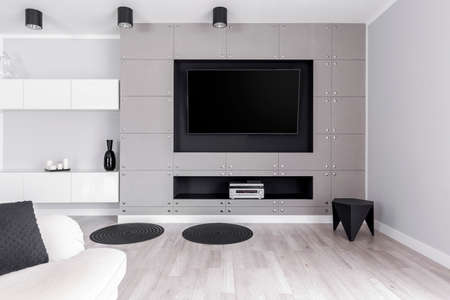 Modern design of white and grey lounge with home cinema