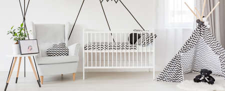 Stylish designed scandinavian style baby room with cradle and tipi tentの写真素材
