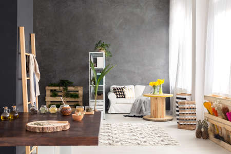 Cozy modern studio apartment with big wooden tableの写真素材