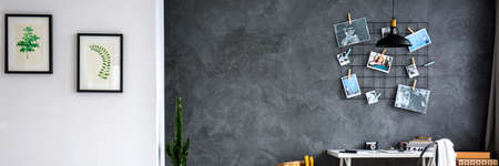 Grey wall in living room decorated with pictures and photosの写真素材