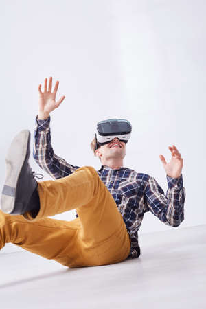 Happy gamer using virtual reality goggles, enjoying video gameの写真素材