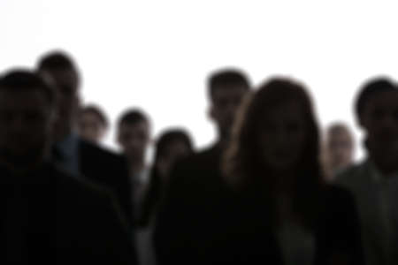 Blurred people silhouettes standing in a crowd