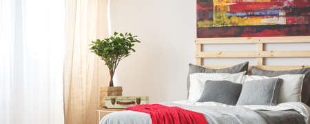 Modern grey interior of bedroom with wooden bedの写真素材