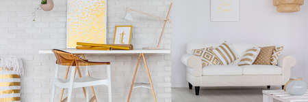 Trendy white and gold living room with white brick wallの写真素材