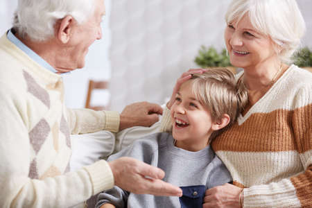 Young happy boy spending time with his grandparentsの写真素材