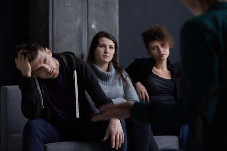 Psychotherapist helping young people with additions on group sessions