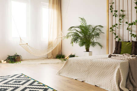 Sand bedroom with rope wall, modern carpet and plant