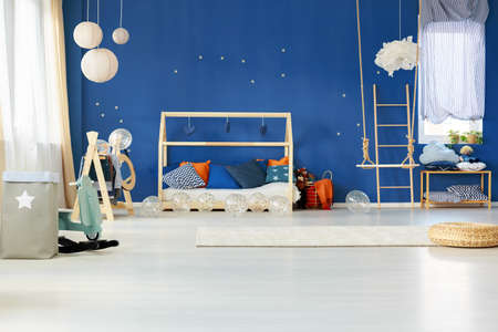 Dreamy child bedroom with blue wall and house bedの写真素材