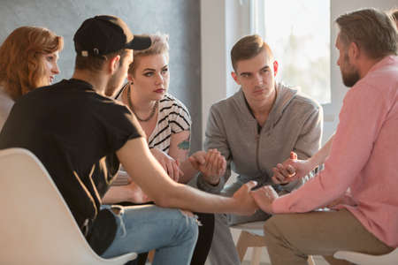 Group of teenagers talking with addiction counselorの写真素材
