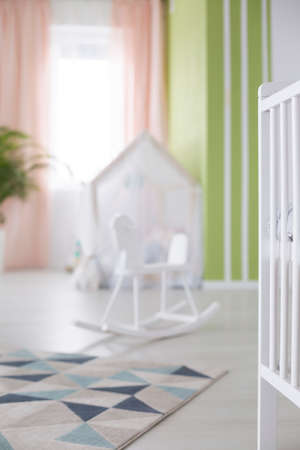Colorful carpet on wooden floor in baby roomの写真素材