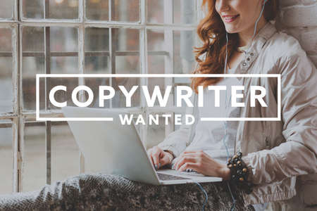 Young smiling beautiful woman working on laptop as freelance copywriter