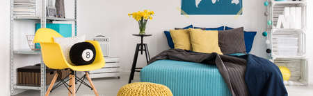 Panorama of contemporary blue and yellow bedroom