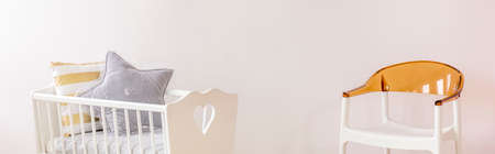 Plastic chair and bassinet standing in the baby roomの写真素材