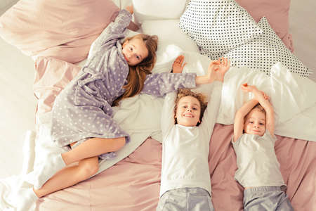 Two little brothers and their sister smilingの写真素材