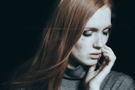 Sad, crying woman having tears on her chickの写真素材