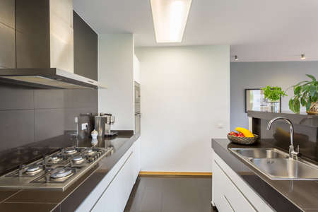 Well lighter kitchen interior with modern furniture and kitchen island