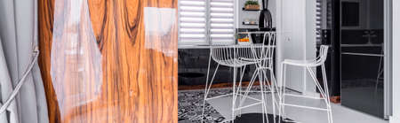 Kitchen interior design with black and white furniture and modern chairs