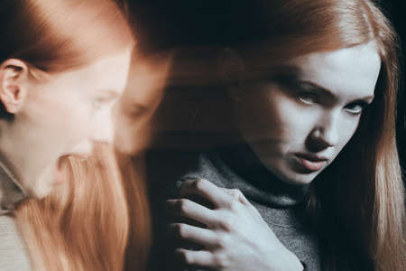 Woman with split personality, hearing voices in headの写真素材