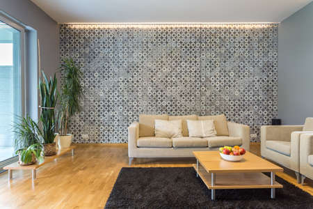 Elegant living room interior with backlight and coffee table located close to the sofaの写真素材