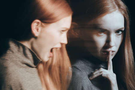 Young and beautiful woman with identity disorderの写真素材